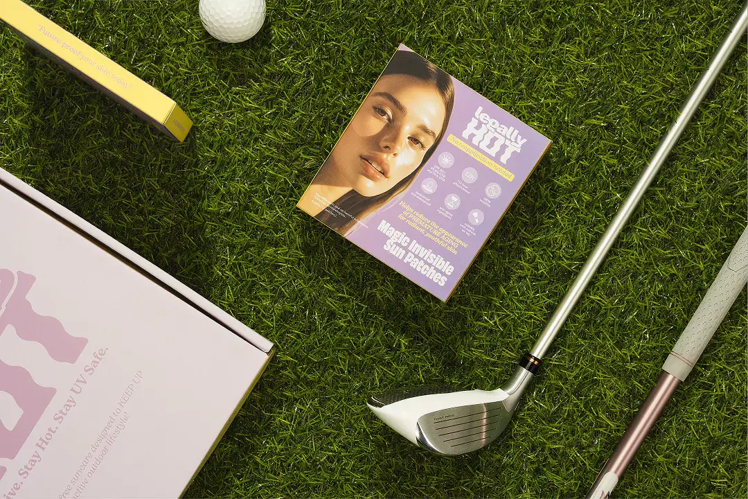 12-Hour Invisible UPF 50+ Sun Patches packaging on grass with golf items nearby.